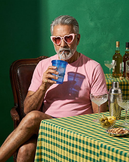 Person sipping from blue Glassy cup