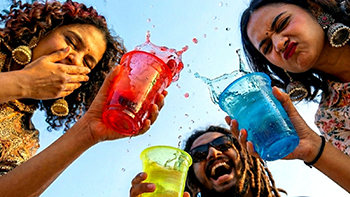 Friends cheering with colourful cups
